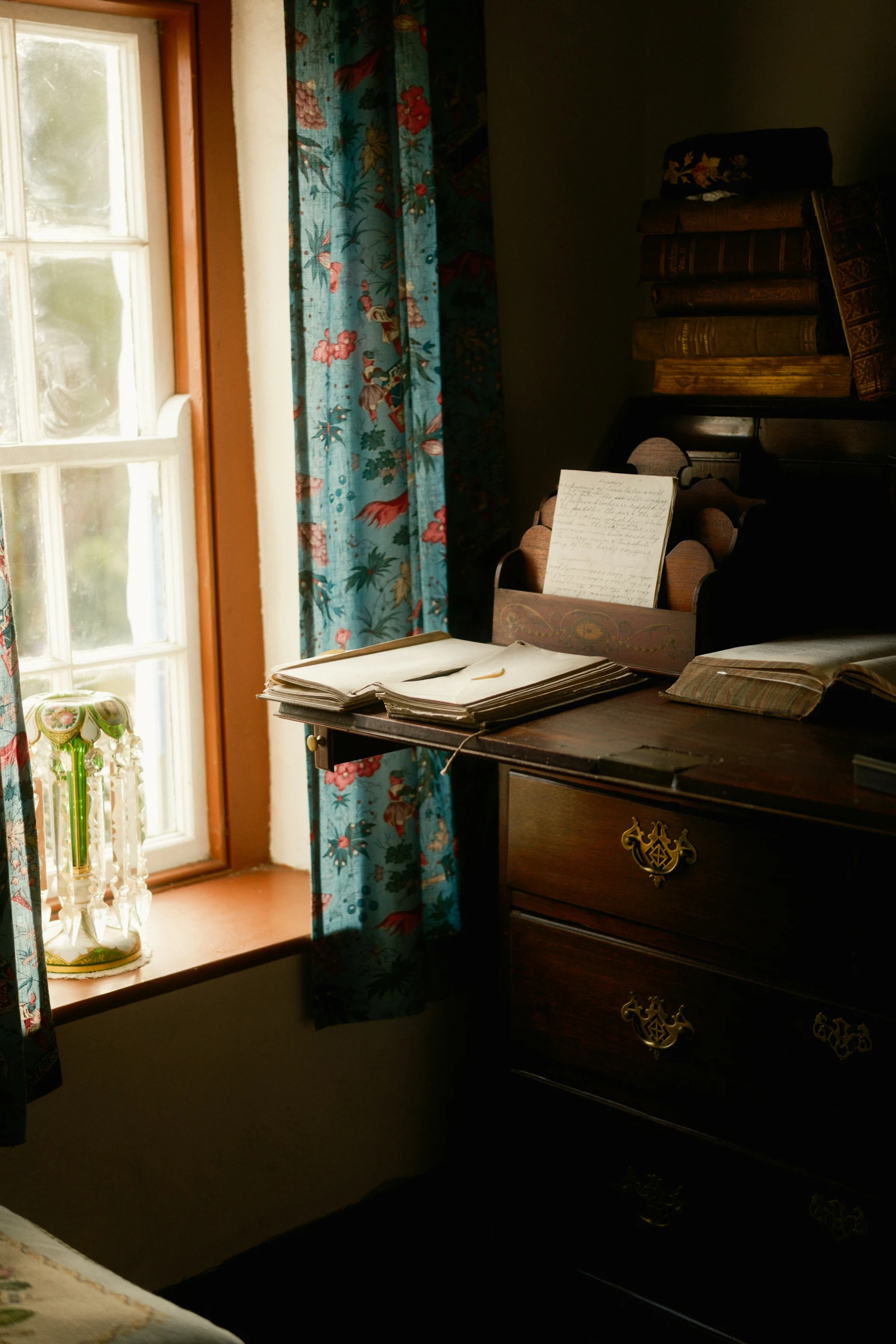 Books on a quiet desk by a window